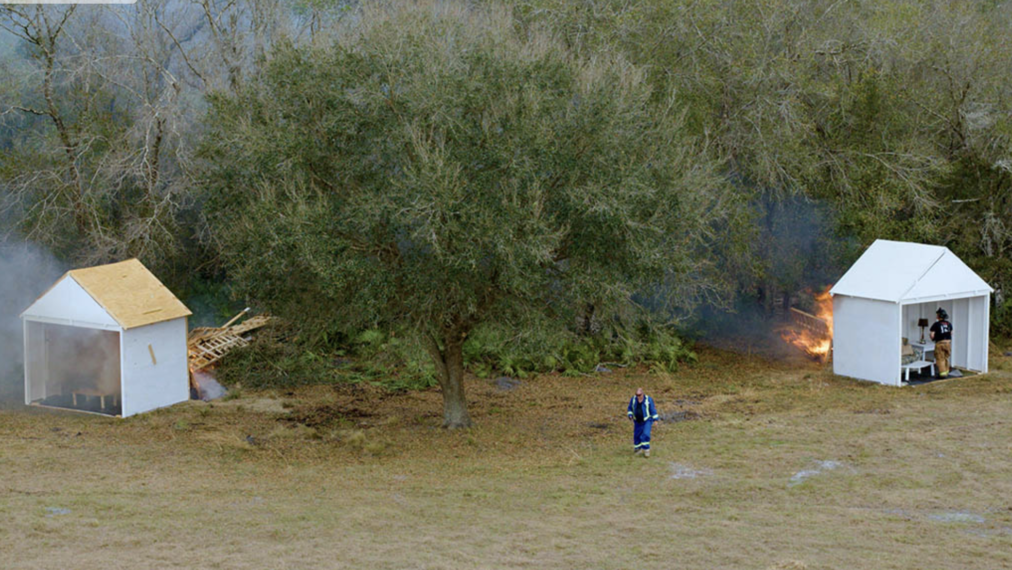 A fire hydrant in the middle of an open field.